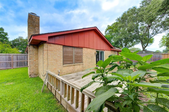 view of home's exterior featuring board and batten siding, a chimney, and brick siding