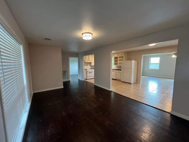 8515 Kempridge St, Houston, TX 77080 - unfurnished living room with baseboards, light wood-type flooring, and ceiling fan
