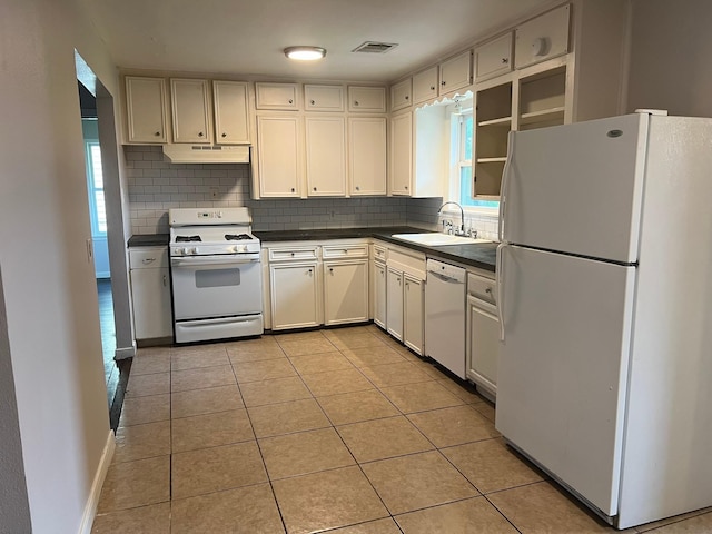 8515 Kempridge St, Houston, TX 77080 - kitchen with white appliances, a sink, dark countertops, decorative backsplash, and under cabinet range hood