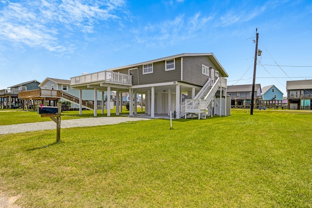 119 Nesmith Pl, Surfside Beach, TX 77541 - back of property featuring stairs, a carport, driveway, and a lawn