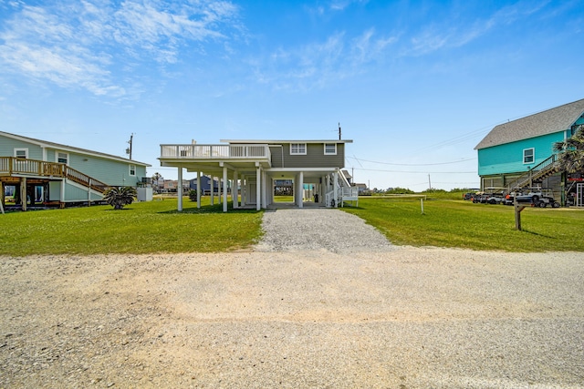 119 Nesmith Pl, Surfside Beach, TX 77541 - coastal inspired home featuring stairway, a carport, driveway, and a front lawn