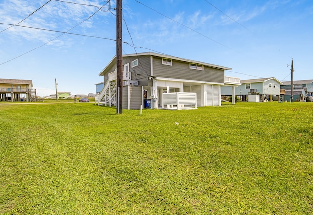 119 Nesmith Pl, Surfside Beach, TX 77541 - rear view of property featuring a lawn