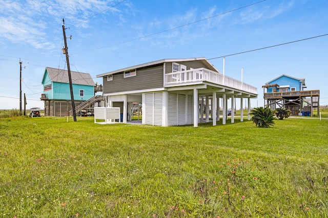 119 Nesmith Pl, Surfside Beach, TX 77541 - rear view of property with a yard, stairs, and a wooden deck
