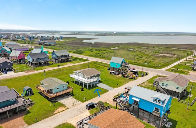 119 Nesmith Pl, Surfside Beach, TX 77541 - aerial perspective of suburban area featuring a nearby body of water