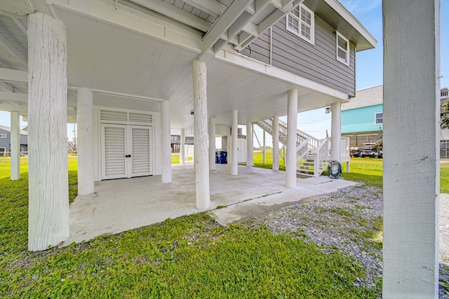 119 Nesmith Pl, Surfside Beach, TX 77541 - porch with a carport, stairs, and a lawn