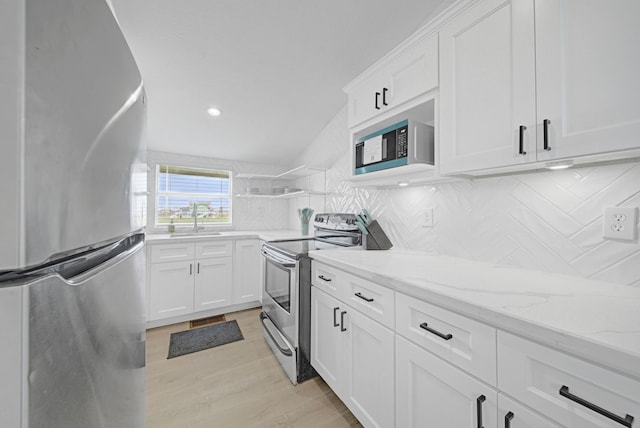 119 Nesmith Pl, Surfside Beach, TX 77541 - kitchen featuring appliances with stainless steel finishes, a sink, tasteful backsplash, white cabinets, and recessed lighting