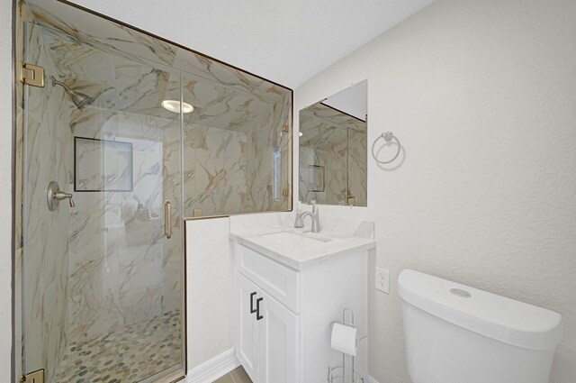 119 Nesmith Pl, Surfside Beach, TX 77541 - bathroom featuring a marble finish shower, toilet, and vanity