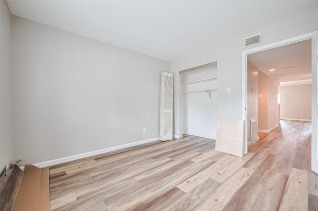 14555 Wunderlich Dr Unit 2307, Houston, TX 77069 - unfurnished bedroom featuring light wood-style floors, a closet, and baseboards