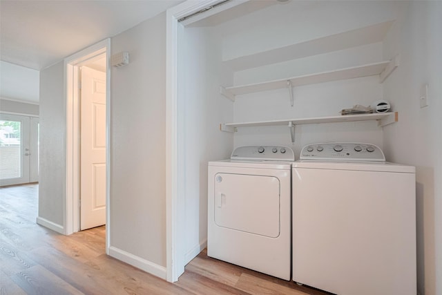 14555 Wunderlich Dr Unit 2307, Houston, TX 77069 - laundry room with independent washer and dryer, light wood-style floors, and baseboards