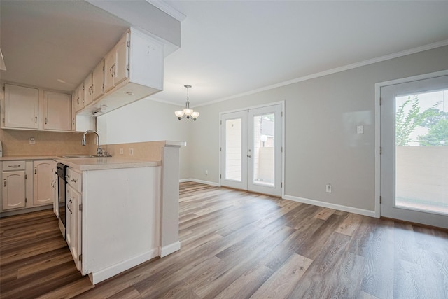 14555 Wunderlich Dr Unit 2307, Houston, TX 77069 - kitchen with a sink, light countertops, wood finished floors, crown molding, and baseboards