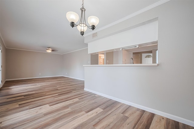 14555 Wunderlich Dr Unit 2307, Houston, TX 77069 - empty room featuring a chandelier, crown molding, baseboards, and light wood-type flooring