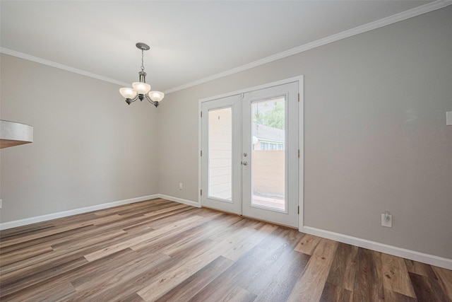 14555 Wunderlich Dr Unit 2307, Houston, TX 77069 - unfurnished room featuring wood finished floors, a chandelier, baseboards, ornamental molding, and french doors