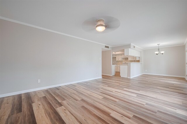 14555 Wunderlich Dr Unit 2307, Houston, TX 77069 - unfurnished living room featuring a chandelier, a ceiling fan, ornamental molding, baseboards, and light wood-style floors