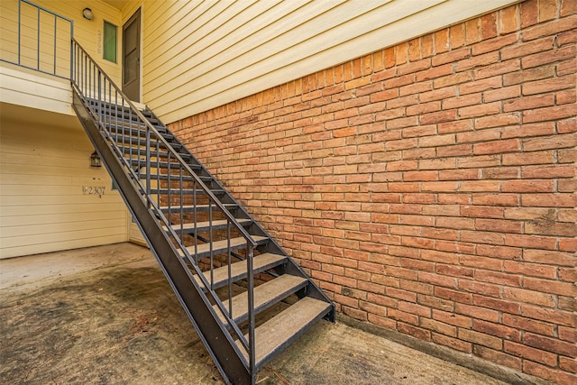 14555 Wunderlich Dr Unit 2307, Houston, TX 77069 - staircase featuring brick wall