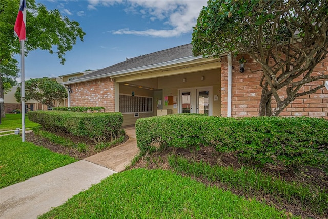 14555 Wunderlich Dr Unit 2307, Houston, TX 77069 - view of front of house featuring brick siding, a front lawn, and roof with shingles