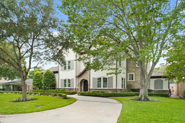 4606 W Alabama St, Houston, TX 77027 - tudor house featuring stone siding, stucco siding, and a front lawn