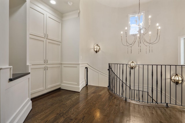 4606 W Alabama St, Houston, TX 77027 - corridor featuring an upstairs landing, dark wood finished floors, a chandelier, a decorative wall, and wainscoting