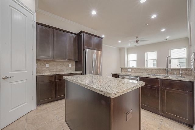 1606 Parker St, Houston, TX 77007 - kitchen with appliances with stainless steel finishes, a sink, ornamental molding, ceiling fan, and light tile patterned floors