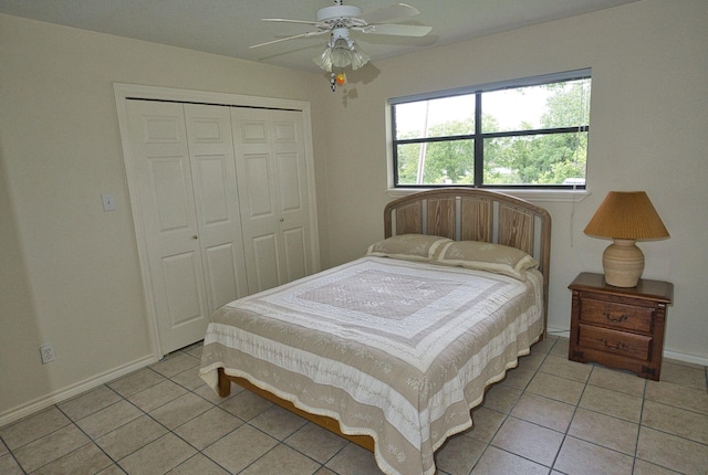 5361 County Road 868e, Brazoria, TX 77422 - bedroom with light tile patterned floors, a closet, baseboards, and a ceiling fan