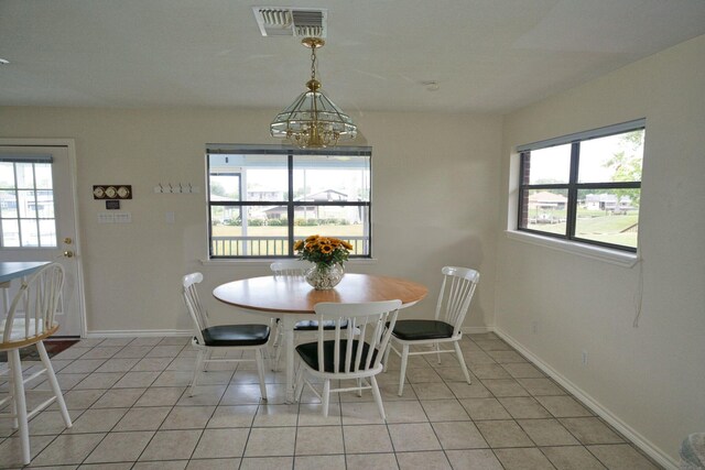 5361 County Road 868e, Brazoria, TX 77422 - dining space featuring light tile patterned flooring, plenty of natural light, a chandelier, and baseboards