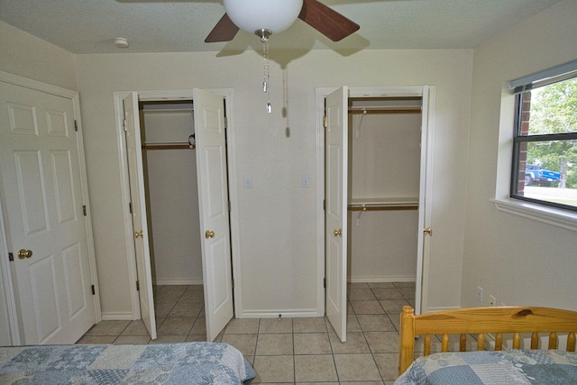 5361 County Road 868e, Brazoria, TX 77422 - bedroom with light tile patterned floors, a ceiling fan, multiple closets, baseboards, and a walk in closet