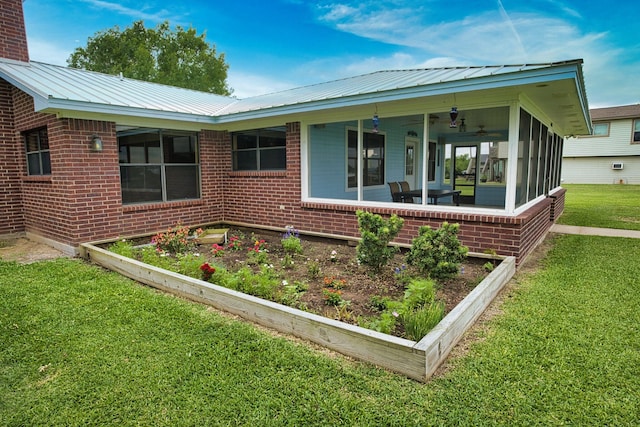 5361 County Road 868e, Brazoria, TX 77422 - view of side of property featuring a yard, brick siding, and a sunroom