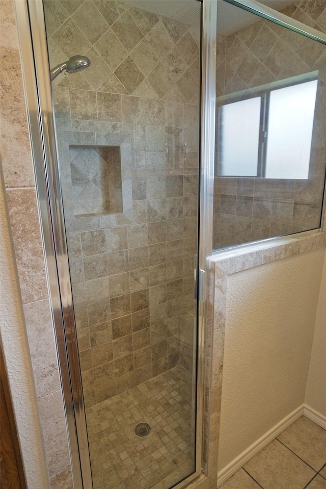 5361 County Road 868e, Brazoria, TX 77422 - full bath with a shower stall, tile patterned flooring, and baseboards