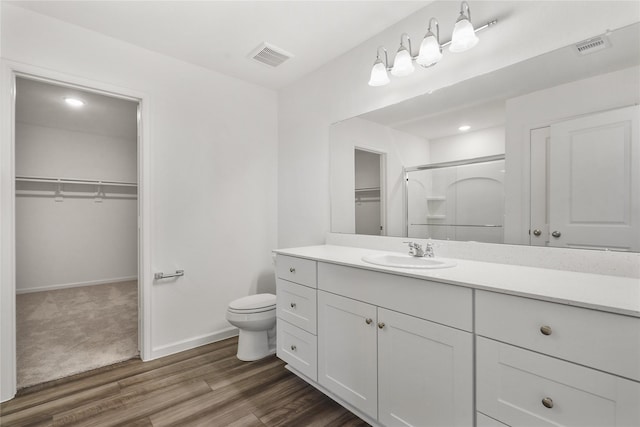27214 Leeward Jetty Dr, Katy, TX 77493 - full bath with toilet, wood finished floors, vanity, a shower with door, and baseboards