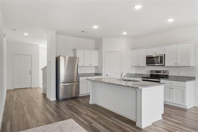 27214 Leeward Jetty Dr, Katy, TX 77493 - kitchen with appliances with stainless steel finishes, a sink, dark wood-style floors, white cabinets, and recessed lighting