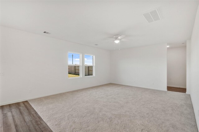 27214 Leeward Jetty Dr, Katy, TX 77493 - carpeted spare room featuring a ceiling fan, baseboards, and wood finished floors