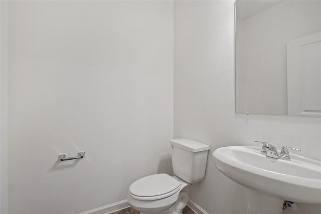 27214 Leeward Jetty Dr, Katy, TX 77493 - bathroom with a sink, baseboards, and toilet