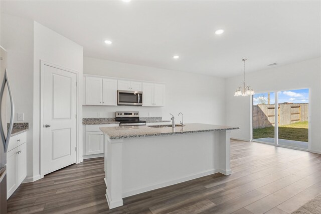 27214 Leeward Jetty Dr, Katy, TX 77493 - kitchen with stainless steel appliances, a sink, dark wood-style flooring, light stone counters, and recessed lighting