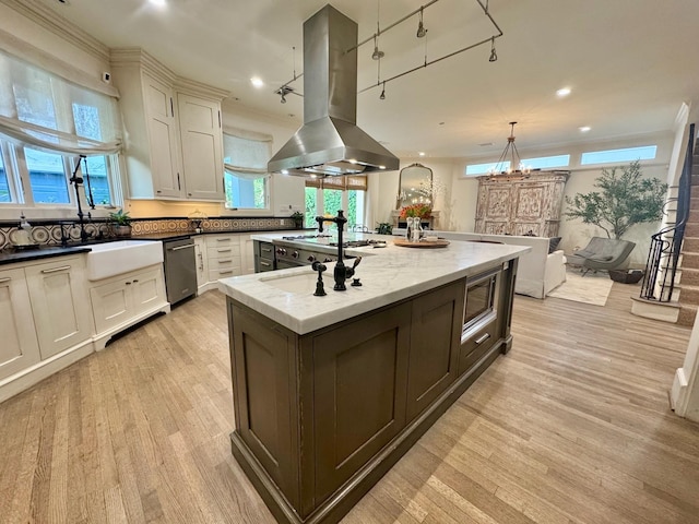 3911 Swarthmore St, Houston, TX 77005 - kitchen with island range hood, stainless steel appliances, light wood-style floors, plenty of natural light, and recessed lighting
