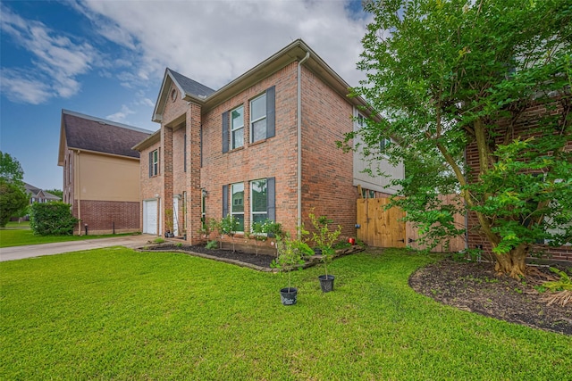 view of front of home with brick siding, driveway, and a garage