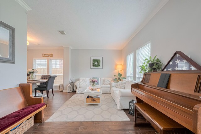living room with ornamental molding, plenty of natural light, dark wood-type flooring, and baseboards