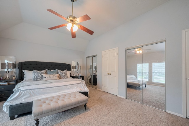 bedroom with multiple closets, carpet floors, vaulted ceiling, baseboards, and a ceiling fan