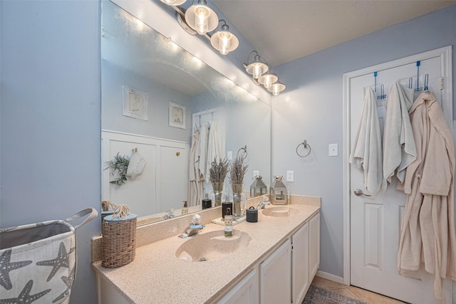 full bathroom featuring tile patterned floors and double vanity