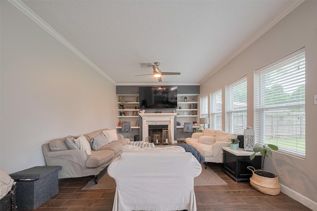 living area featuring crown molding, wood tiled floors, a fireplace, ceiling fan, and baseboards
