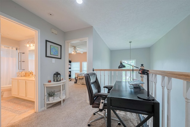 home office with a chandelier, plenty of natural light, ceiling fan, carpet floors, and a textured ceiling