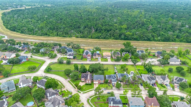 aerial perspective of suburban area featuring a heavily wooded area