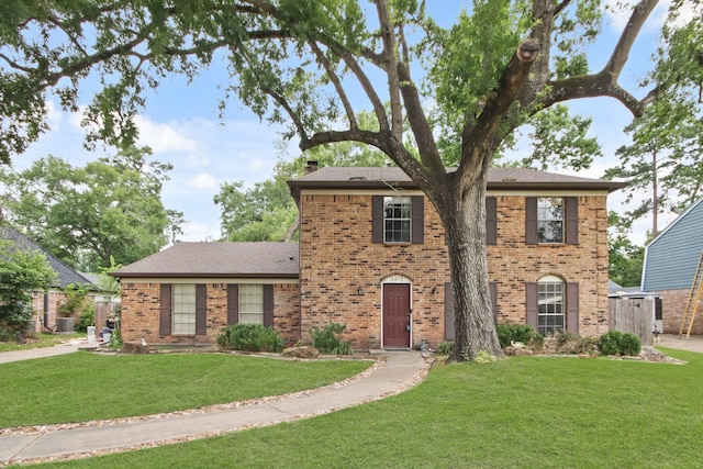 2211 Willow Point Dr, Houston, TX 77339 - view of front of property with brick siding, a front yard, and central AC
