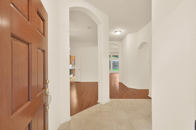 3722 Lovers Ln, Montgomery, TX 77356 - hallway with light tile patterned floors, arched walkways, and baseboards