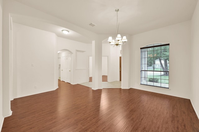 3722 Lovers Ln, Montgomery, TX 77356 - empty room with arched walkways, wood finished floors, a chandelier, and baseboards