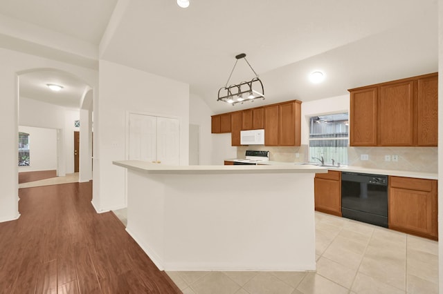 3722 Lovers Ln, Montgomery, TX 77356 - kitchen featuring dishwasher, white microwave, range with electric stovetop, brown cabinets, and a sink