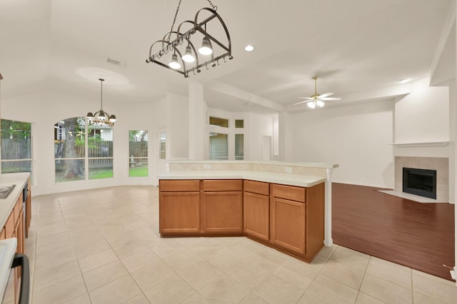 3722 Lovers Ln, Montgomery, TX 77356 - kitchen with open floor plan, light tile patterned floors, a chandelier, light countertops, and a tile fireplace