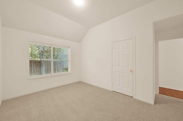 3722 Lovers Ln, Montgomery, TX 77356 - spare room featuring carpet, vaulted ceiling, and baseboards