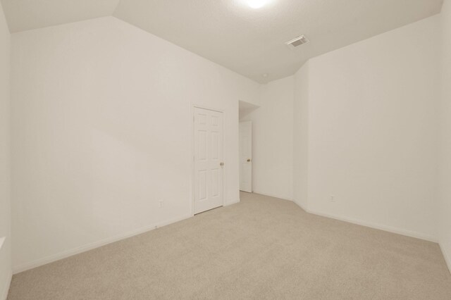 3722 Lovers Ln, Montgomery, TX 77356 - empty room featuring light colored carpet, vaulted ceiling, and baseboards