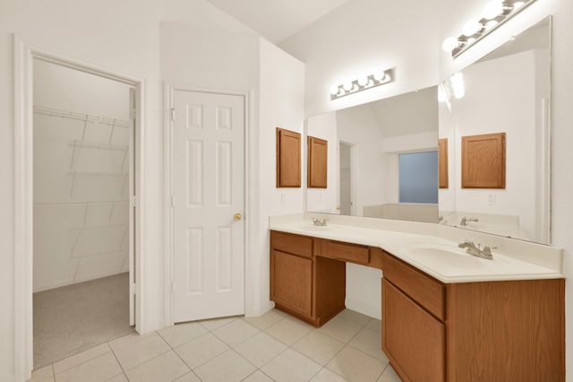3722 Lovers Ln, Montgomery, TX 77356 - bathroom with double vanity, a spacious closet, tile patterned flooring, and vaulted ceiling