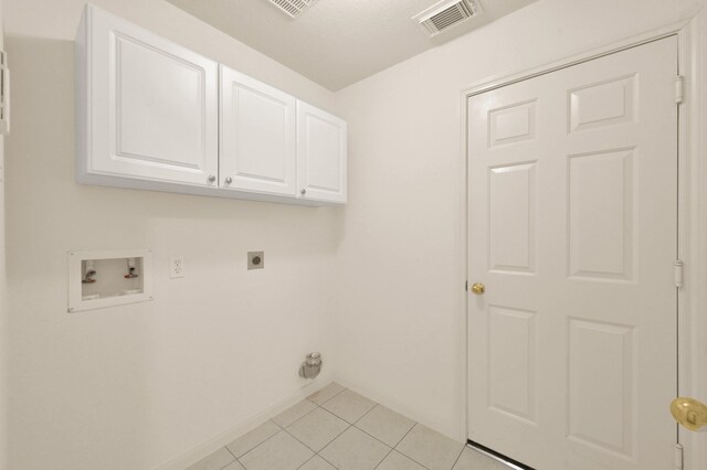 3722 Lovers Ln, Montgomery, TX 77356 - washroom featuring electric dryer hookup, hookup for a washing machine, cabinet space, light tile patterned flooring, and baseboards