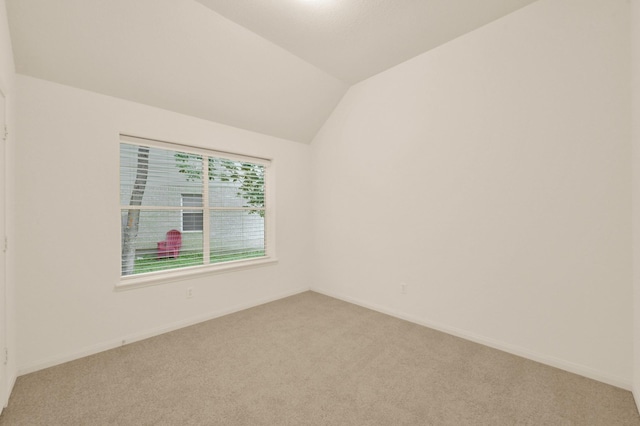 3722 Lovers Ln, Montgomery, TX 77356 - unfurnished room with light colored carpet, baseboards, and vaulted ceiling